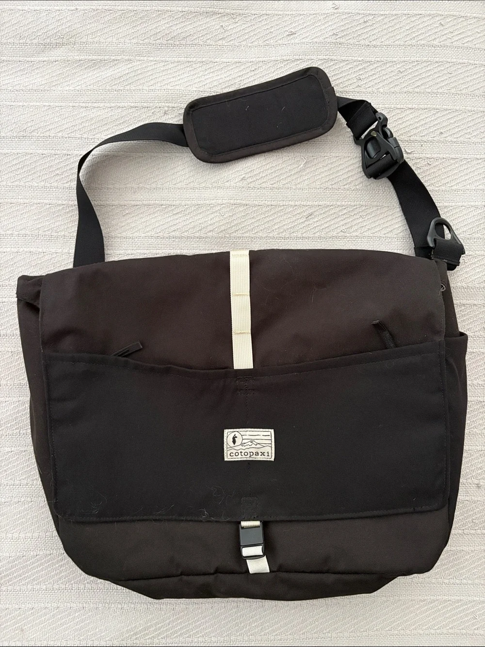 cotopaxi Black Messenger Bag with Cream Stripe